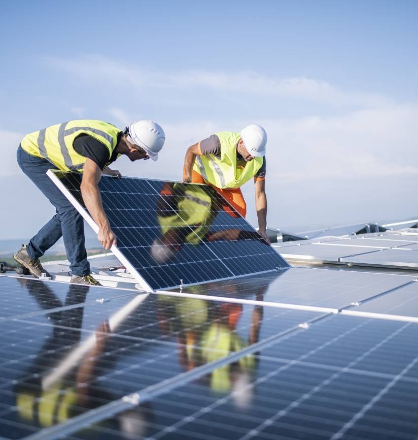 Solar panel workers installing solar panels